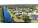 Waterfront home with an enclosed pool and lush surroundings, providing a private oasis at 6172 Knotty Pine Ct, Port Orange, FL 32127