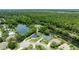 Stunning aerial view of home with lush green surroundings, lake and waterfront access at 6172 Knotty Pine Ct, Port Orange, FL 32127