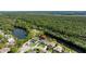 Aerial perspective of a waterfront home, beautifully integrated within a lush, green environment at 6172 Knotty Pine Ct, Port Orange, FL 32127