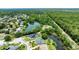An attractive aerial view of a home with lush green surroundings and waterfront at 6172 Knotty Pine Ct, Port Orange, FL 32127
