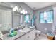 Charming bathroom features blue accents, decorative mirrors, and a bright, airy feel at 6172 Knotty Pine Ct, Port Orange, FL 32127