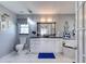 Elegant bathroom featuring marble floors, modern vanity, soaking tub, and decorative mirror at 6172 Knotty Pine Ct, Port Orange, FL 32127