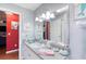 A decorative bathroom features a large mirror and coastal accents in a pleasing color palette at 6172 Knotty Pine Ct, Port Orange, FL 32127