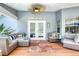 Comfortable covered patio with plush seating, a ceiling fan, and a stylish rug overlooking the pool area at 6172 Knotty Pine Ct, Port Orange, FL 32127