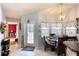 Bright dining area features tile floors, an elegant light fixture, and a charming dining table at 6172 Knotty Pine Ct, Port Orange, FL 32127