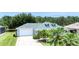Charming single-story home boasts a two-car garage and beautiful landscaping with manicured lawn at 6172 Knotty Pine Ct, Port Orange, FL 32127
