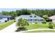 Inviting single-story home featuring lush landscaping, mature trees, and a well-maintained front lawn at 6172 Knotty Pine Ct, Port Orange, FL 32127