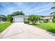 Lovely home with a long driveway leading to a two-car garage and a charming front porch at 6172 Knotty Pine Ct, Port Orange, FL 32127