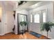 Bright foyer with hardwood floors, a decorative mirror, and glass paneled front door at 6172 Knotty Pine Ct, Port Orange, FL 32127
