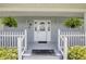 Close up of the front porch with ferns and a leaded glass front door at 6172 Knotty Pine Ct, Port Orange, FL 32127