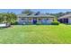 Charming single-Gathering home featuring a lush green lawn, a front porch, and lovely landscaping at 6172 Knotty Pine Ct, Port Orange, FL 32127