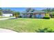 Charming single-Gathering home featuring a lush green lawn, a front porch, and lovely landscaping at 6172 Knotty Pine Ct, Port Orange, FL 32127