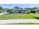 Charming single-Gathering home featuring a lush green lawn, a front porch, and lovely landscaping at 6172 Knotty Pine Ct, Port Orange, FL 32127