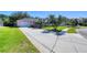Well-manicured front yard, with palm trees, leading up to a charming single-Gathering home with a garage and porch at 6172 Knotty Pine Ct, Port Orange, FL 32127