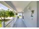 Inviting front porch with ferns and a seaside decoration at 6172 Knotty Pine Ct, Port Orange, FL 32127
