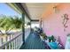 Relaxing outdoor seating on the covered front porch overlooking the street and green space at 6172 Knotty Pine Ct, Port Orange, FL 32127