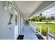 Welcoming front porch features a decorative glass front door, ferns, and well-maintained landscaping at 6172 Knotty Pine Ct, Port Orange, FL 32127