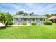 Well-maintained home with lush front lawn, mature landscaping, and a charming covered front porch at 6172 Knotty Pine Ct, Port Orange, FL 32127