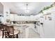 Well-lit kitchen with ample counter space, white cabinets, and tiled floors at 6172 Knotty Pine Ct, Port Orange, FL 32127