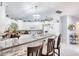 Well-lit kitchen with ample counter space, white cabinets, and tiled floors at 6172 Knotty Pine Ct, Port Orange, FL 32127
