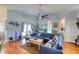 Open concept living room featuring a large blue sectional and bright, airy atmosphere at 6172 Knotty Pine Ct, Port Orange, FL 32127