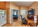 Spacious home office with glass doors leading into the cozy living room at 6172 Knotty Pine Ct, Port Orange, FL 32127