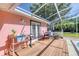 Inviting screened-in patio with wood flooring, outdoor decor and a lovely outdoor dining set at 6172 Knotty Pine Ct, Port Orange, FL 32127
