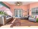 Inviting covered patio with comfortable seating, ceiling fan, and stylish decor for outdoor relaxation at 6172 Knotty Pine Ct, Port Orange, FL 32127