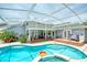 Relaxing screened-in pool area with ample deck space for outdoor entertaining and a sparkling blue swimming pool at 6172 Knotty Pine Ct, Port Orange, FL 32127