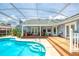 Inviting backyard featuring a sparkling pool, deck area, perfect for relaxation and outdoor entertaining at 6172 Knotty Pine Ct, Port Orange, FL 32127