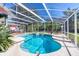 Large screened-in pool area featuring a spa, inground pool, deck and tranquil backyard views at 6172 Knotty Pine Ct, Port Orange, FL 32127