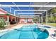 Screened pool with hot tub and a covered deck, perfect for relaxation and outdoor living at 6172 Knotty Pine Ct, Port Orange, FL 32127