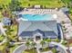 Aerial view of clubhouse, pool area, sun loungers, cabanas, palm trees, and well-manicured landscaping at 1010 Megano Blvd, Deland, FL 32724