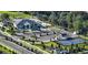 An aerial view features a pickleball court and community center with ample parking and landscaped grounds at 1010 Megano Blvd, Deland, FL 32724