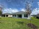 Well-maintained backyard featuring a covered patio and lush green lawn at 1010 Megano Blvd, Deland, FL 32724
