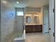 Beautiful bathroom with marble tile, a glass-enclosed shower, and double vanities at 1010 Megano Blvd, Deland, FL 32724