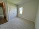 Cozy bedroom with neutral carpet, a closet, and a window at 1010 Megano Blvd, Deland, FL 32724