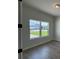 A view from a room looking out two large windows to the front yard and neighborhood beyond at 1010 Megano Blvd, Deland, FL 32724