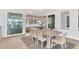Bright dining area showcasing an elegant table set, area rug, and sliding glass doors to outdoor patio at 1010 Megano Blvd, Deland, FL 32724