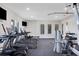 Modern gym equipped with treadmills, elliptical machines, weight machines, and TVs at 1010 Megano Blvd, Deland, FL 32724