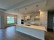 Modern kitchen with white cabinets, an island with pendant lighting, and stainless steel appliances at 1010 Megano Blvd, Deland, FL 32724