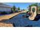 Community playground with a slide and soft blue and brown ground cover for comfort and safety at 1010 Megano Blvd, Deland, FL 32724