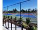 Well-maintained community tennis courts surrounded by a secure fence, landscaping, and bike racks at 1010 Megano Blvd, Deland, FL 32724