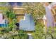 Overhead view of home highlighting the backyard with firepit, vinyl fence, landscaping, and surrounding trees at 1433 Mollie Rd, Daytona Beach, FL 32114