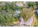 Aerial view of the property showing the roof, driveway, landscaped front yard, and tree coverage at 1433 Mollie Rd, Daytona Beach, FL 32114