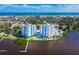 Panoramic aerial shot showcases the two condominium buildings overlooking a pool and a picturesque waterfront at 925 N Halifax Ave # 1105, Daytona Beach, FL 32118