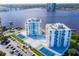 Aerial view of twin condo buildings with tennis courts, a central courtyard, and ample parking at 925 N Halifax Ave # 1105, Daytona Beach, FL 32118