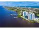 Breathtaking aerial view showcasing two high-rise towers surrounded by a bay, community pool, and coastal beauty at 925 N Halifax Ave # 1105, Daytona Beach, FL 32118