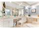 This bathroom features dual sinks, a bathtub, and a vanity space at 925 N Halifax Ave # 1105, Daytona Beach, FL 32118
