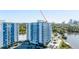 Exterior view of a modern high-rise apartment building with expansive balconies and water views at 925 N Halifax Ave # 1105, Daytona Beach, FL 32118